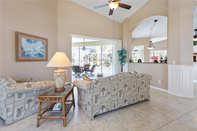 living room with high vaulted ceiling and ceiling fan