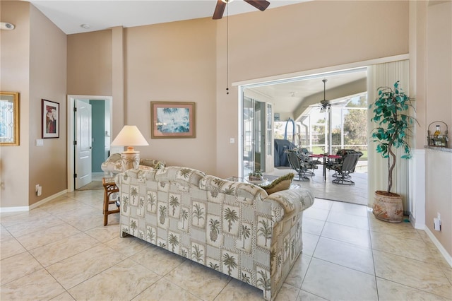 tiled living room with a towering ceiling and ceiling fan