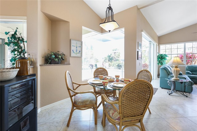 dining space featuring vaulted ceiling and light tile patterned floors