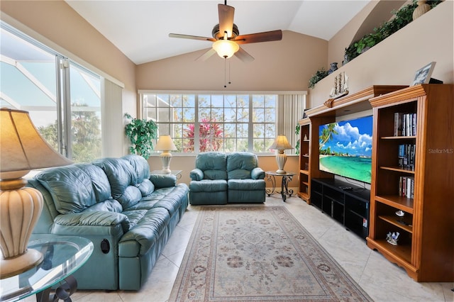 living room featuring ceiling fan, lofted ceiling, light tile patterned floors, and a wealth of natural light