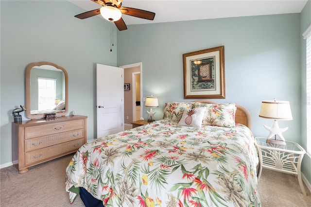 carpeted bedroom featuring ceiling fan and vaulted ceiling