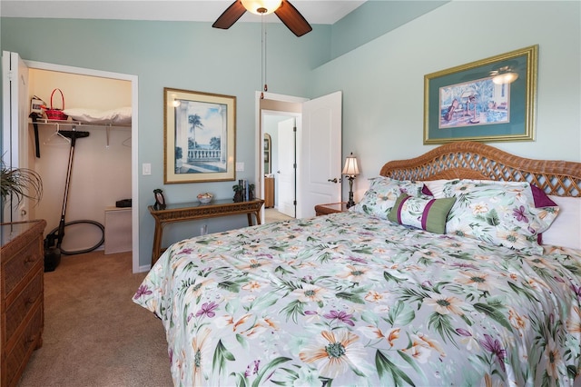 bedroom featuring ceiling fan, vaulted ceiling, light carpet, a walk in closet, and a closet