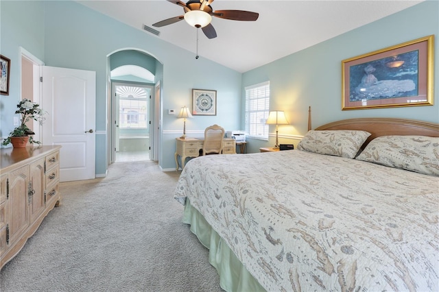 bedroom featuring light carpet, vaulted ceiling, and ceiling fan