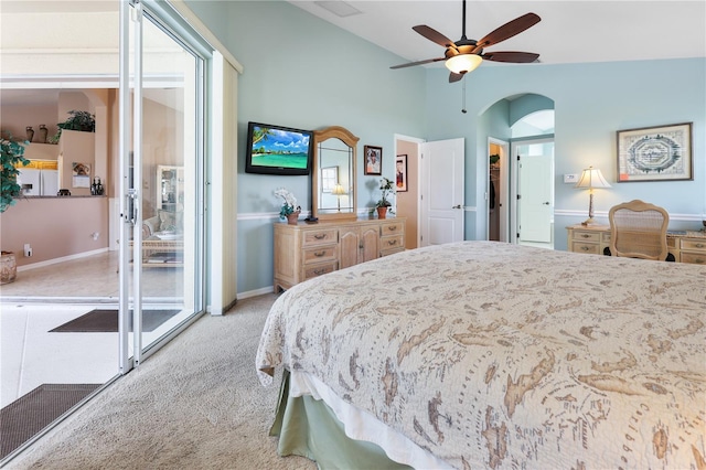 bedroom with ceiling fan, light colored carpet, lofted ceiling, and access to exterior