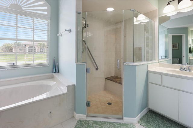 bathroom with vanity, tile patterned flooring, and separate shower and tub