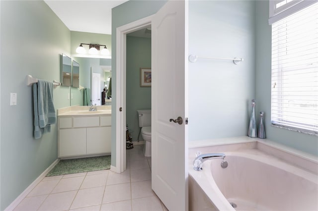 bathroom with a washtub, vanity, tile patterned flooring, and toilet