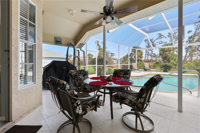 view of patio featuring a lanai, a grill, and ceiling fan