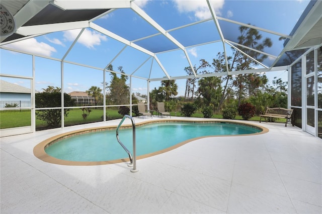 view of swimming pool featuring a patio area and glass enclosure