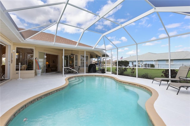 view of pool featuring a patio and glass enclosure