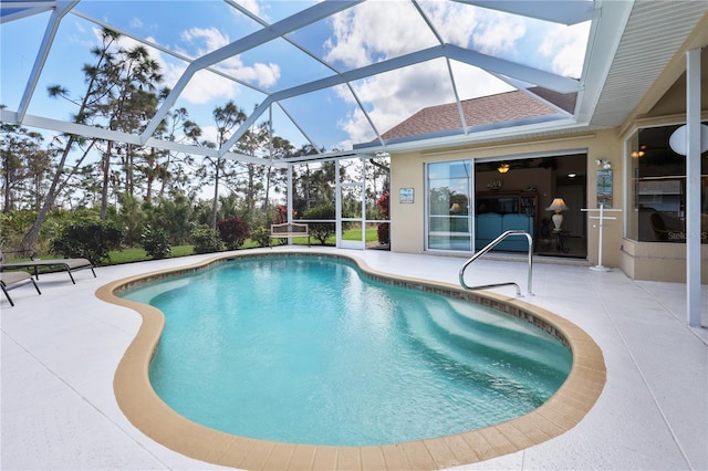 view of swimming pool with a patio and glass enclosure