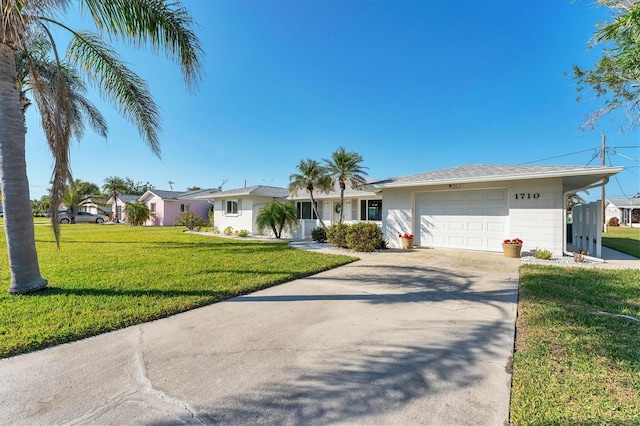 ranch-style home with a garage and a front yard