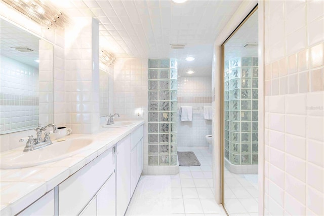 11000 Placida Rd Unit 101, Placida, FL 33946 - bathroom with tile walls, double vanity, and tile patterned flooring