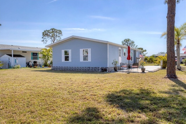 view of property exterior with a lawn and a patio area