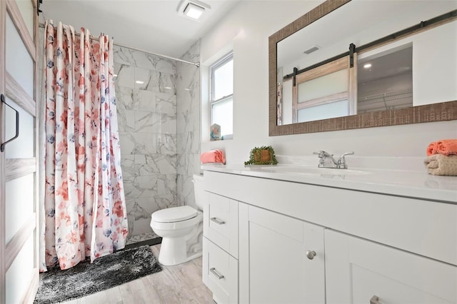 bathroom featuring vanity, hardwood / wood-style floors, curtained shower, and toilet