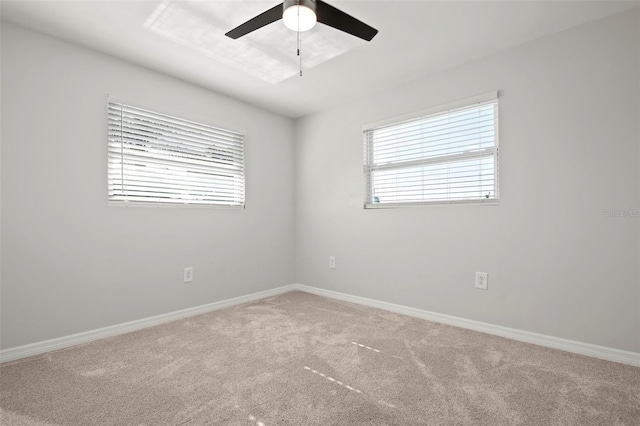 carpeted spare room featuring ceiling fan