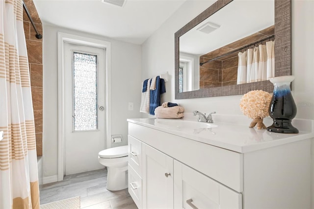 full bathroom with vanity, toilet, and shower / bath combo with shower curtain