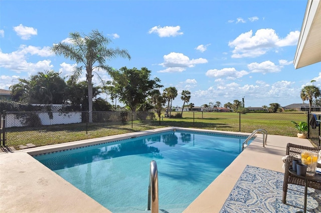 view of swimming pool featuring a patio area and a lawn