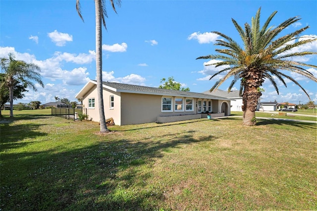 ranch-style home with a front lawn