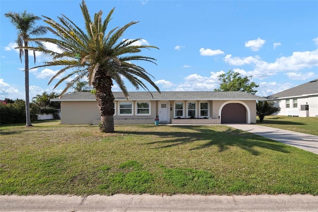 view of front of house featuring a garage and a front yard