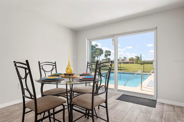 84 Caddy Rd, Rotonda West, FL 33947 - dining room with baseboards and light wood-style floors