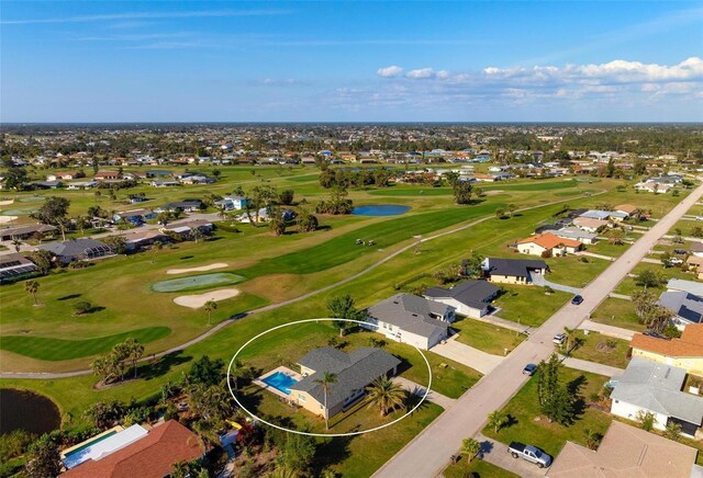 84 Caddy Rd, Rotonda West, FL 33947 - aerial perspective of suburban area featuring a golf club and a large body of water