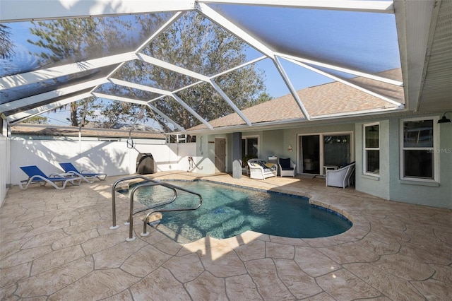 view of swimming pool featuring a patio and a lanai