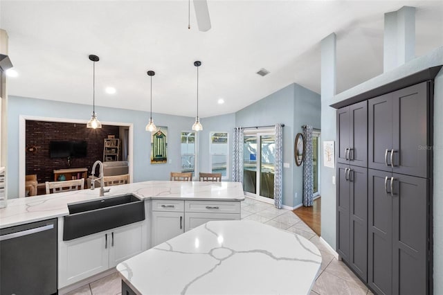 kitchen with a center island, sink, stainless steel dishwasher, and white cabinets