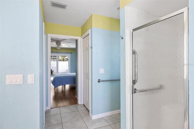 bathroom featuring tile patterned floors and a shower with door