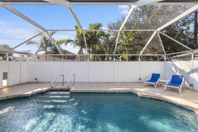 view of pool with a lanai and a patio