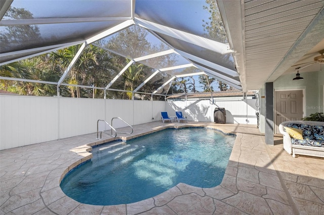 view of swimming pool featuring a lanai, a patio, and ceiling fan