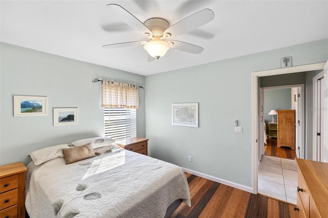 bedroom with dark wood-type flooring and ceiling fan