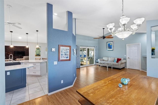 dining room featuring sink, ceiling fan with notable chandelier, and light hardwood / wood-style flooring