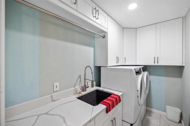 laundry room with cabinets, independent washer and dryer, and sink