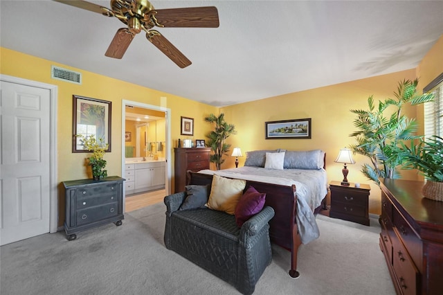 carpeted bedroom featuring connected bathroom and ceiling fan