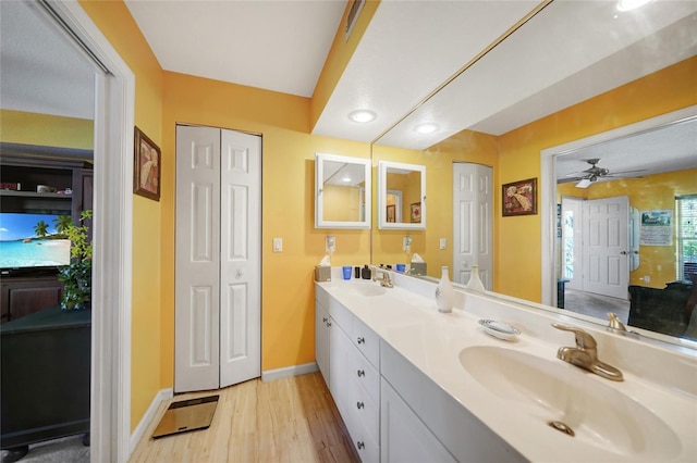 bathroom featuring vanity, hardwood / wood-style flooring, and ceiling fan