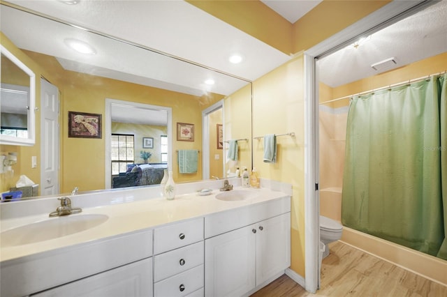 bathroom featuring vanity, toilet, and wood-type flooring