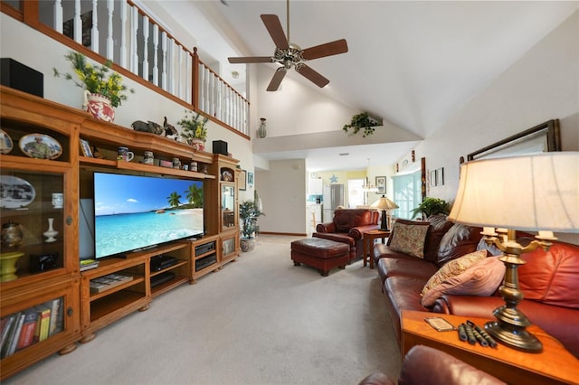 carpeted living room with a towering ceiling and ceiling fan