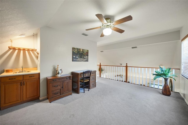 office with light colored carpet, lofted ceiling, and sink