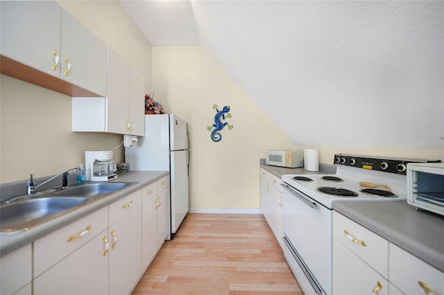 kitchen featuring lofted ceiling, sink, light hardwood / wood-style flooring, white appliances, and white cabinets