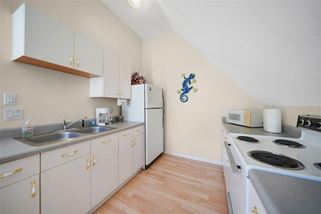 kitchen with white cabinetry, sink, white appliances, and vaulted ceiling