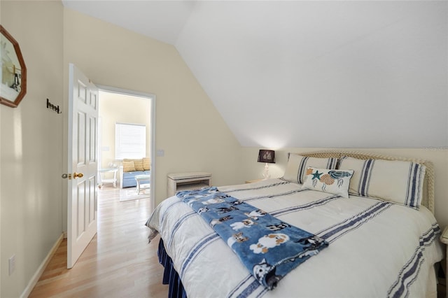 bedroom with light hardwood / wood-style flooring and vaulted ceiling