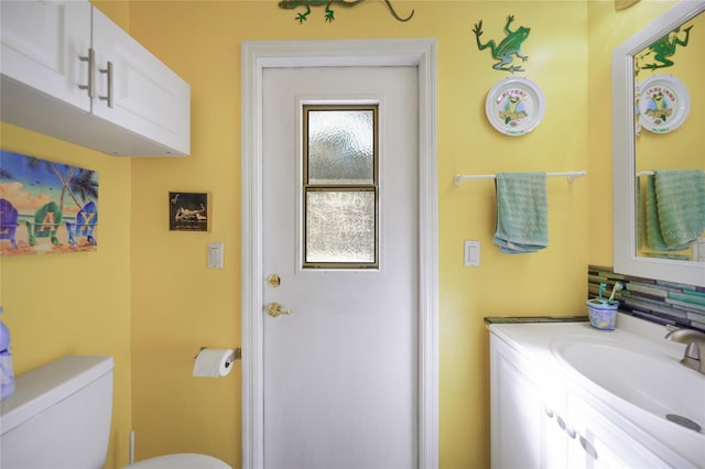 bathroom featuring vanity and toilet