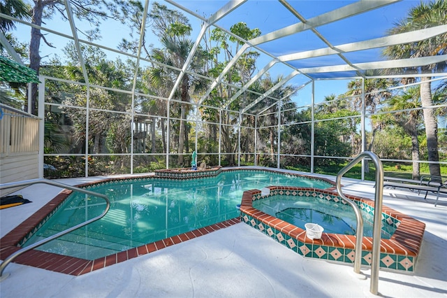 view of swimming pool featuring an in ground hot tub, a lanai, and a patio area