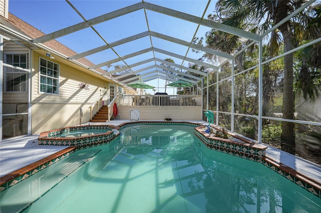 view of swimming pool featuring an in ground hot tub and glass enclosure