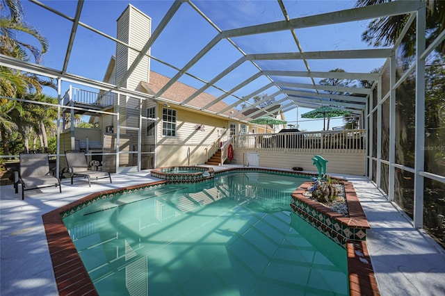 view of pool with an in ground hot tub, a lanai, and a patio area