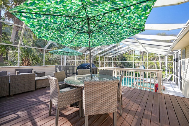 wooden terrace with grilling area, a lanai, and an outdoor hangout area