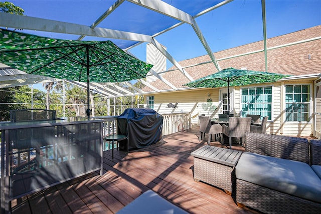 wooden terrace featuring a grill and glass enclosure