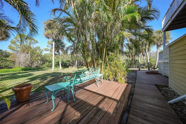 wooden deck featuring a yard