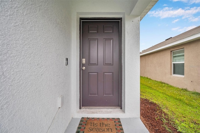 property entrance featuring stucco siding