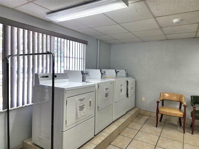 laundry room featuring washing machine and clothes dryer and light tile patterned floors